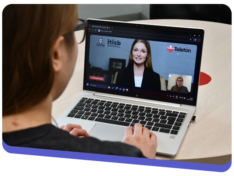 Person participates in a video conference on a laptop; the main screen shows a woman speaking, with a small inset window of another participant and Telethon branding in the background on screen.