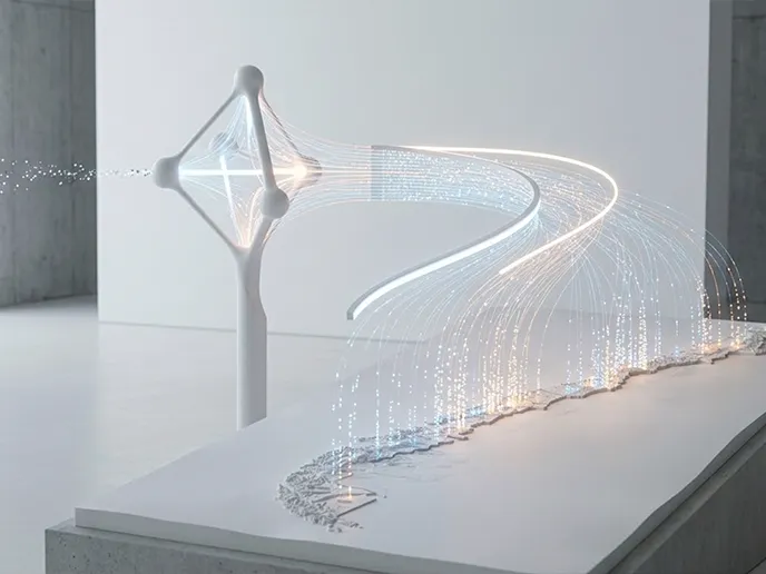 White abstract sculpture with glowing light trails flowing along a curved platform in a gallery setting.